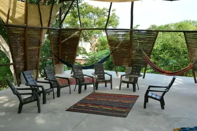 a group of chairs and a table in a tent at Puerta al Mar Ecolodge Glamping in Tubará