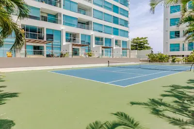a tennis court in front of a building at Apartamento de lujo en Cartagena Seaway935 - Morros in Cartagena de Indias