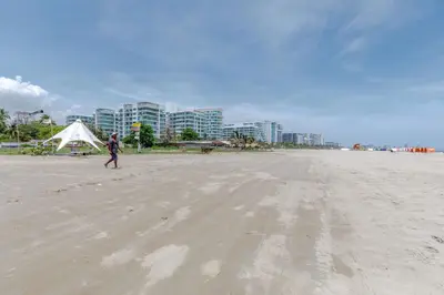 a person walking on the beach with a kite at Apartamento de lujo en Cartagena Seaway935 - Morros in Cartagena de Indias