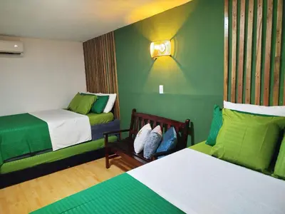 a hotel room with two beds and a couch at Hb5 Family Room with private bathroom facing the sea in Cartagena de Indias