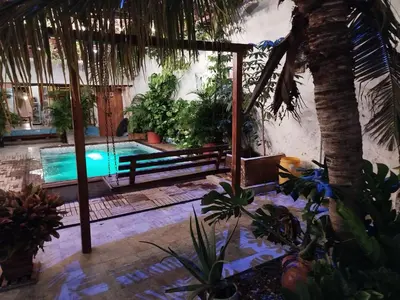 a resort with a swimming pool and a palm tree at Hb5 Family Room with private bathroom facing the sea in Cartagena de Indias