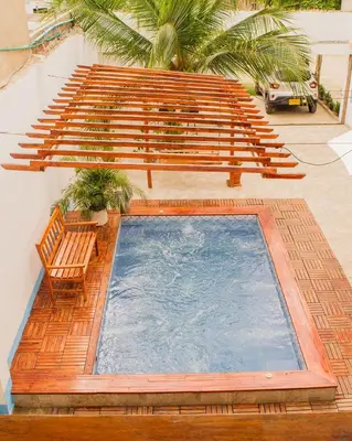 a swimming pool with a bench and a bench at Hb7 Quadruple Room with shared bathroom in Cartagena de Indias