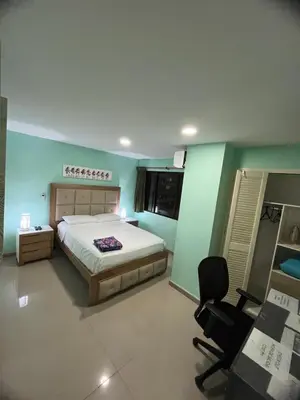 a bedroom with a bed and a desk and a chair at Frente al mar, Boca grande APT1105 in Cartagena de Indias