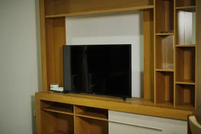a flat screen tv sitting on a wooden entertainment center at Frente al mar, Boca grande APT1105 in Cartagena de Indias