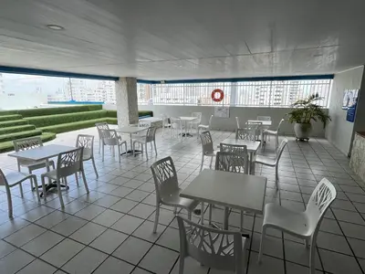 a cafeteria with tables and chairs in a building at Frente al mar, Boca grande APT1105 in Cartagena de Indias