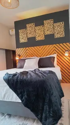 a bedroom with a bed with a black comforter at Beach House In La Boquilla Facing the Sea With Air Conditioning and WIFI in Cartagena de Indias