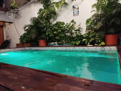 a large swimming pool with plants in a room at Beach House In La Boquilla Facing the Sea With Air Conditioning and WIFI in Cartagena de Indias