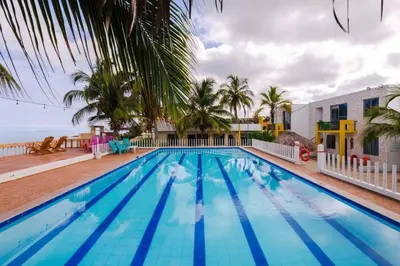 a swimming pool with a view of the ocean at Cabaña en condominio frente al mar #10 in Tolú