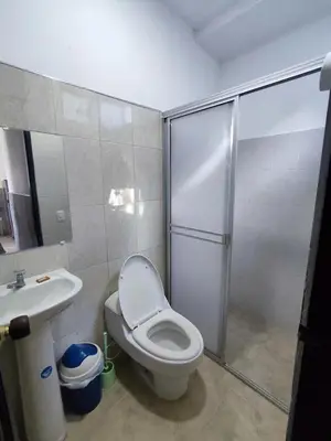 a bathroom with a shower and a toilet and a sink at Cabaña en condominio frente al mar #10 in Tolú