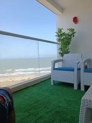 a room with a balcony with a view of the beach at Apartamento Frente al Mar Amoblado Cartagena in Cartagena de Indias