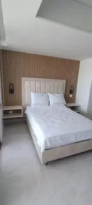 a bedroom with a large bed with white sheets at Apartamento Frente al Mar Amoblado Cartagena in Cartagena de Indias