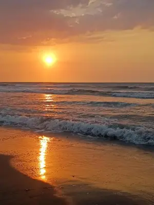 a sunset on a beach with the ocean at Apartamento Frente al Mar Amoblado Cartagena in Cartagena de Indias