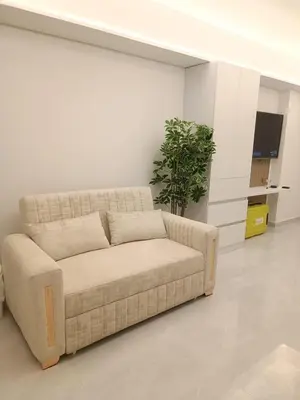 a living room with a couch and a plant at Apartamento Frente al Mar Amoblado Cartagena in Cartagena de Indias