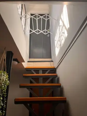 a set of stairs in a house with a window at ¡La mejor Suite! Lujo, ubicación, precio in Barranquilla