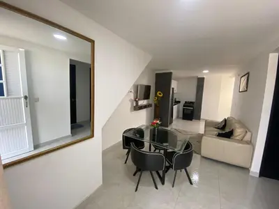 a living room with a glass table and a mirror at lindo Apartamento completo in Cartagena de Indias