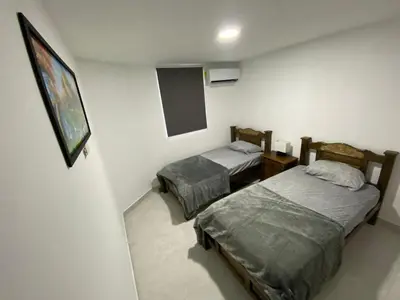 a room with two beds and a chalkboard on the wall at lindo Apartamento completo in Cartagena de Indias