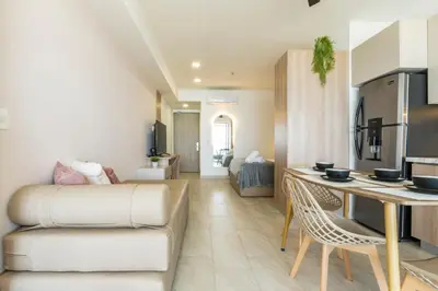 a kitchen and living room with a table and chairs at Panoramic Oceanview Loft Near Beach & Airport in Cartagena de Indias