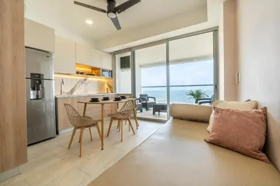 a kitchen and living room with a table and chairs at Panoramic Oceanview Loft Near Beach & Airport in Cartagena de Indias