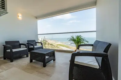 a room with chairs and a view of the ocean at Panoramic Oceanview Loft Near Beach & Airport in Cartagena de Indias