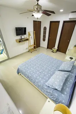 a large bed in a room with a ceiling fan at Paraíso Costero Morros Vitri La Boquilla familiar 4 personas in Cartagena de Indias