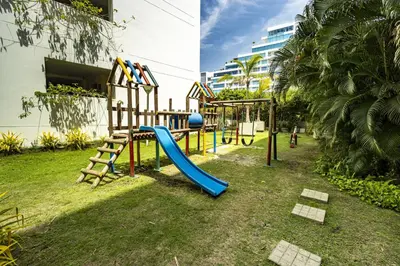a playground with a slide in a yard at Paraíso Costero Morros Vitri La Boquilla familiar 4 personas in Cartagena de Indias