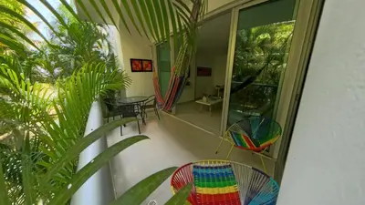 a room with a balcony with chairs and windows at Paraíso Costero Morros Vitri La Boquilla familiar 4 personas in Cartagena de Indias
