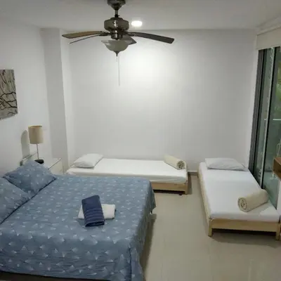 a bedroom with two beds and a ceiling fan at Paraíso Costero Morros Vitri La Boquilla familiar 4 personas in Cartagena de Indias