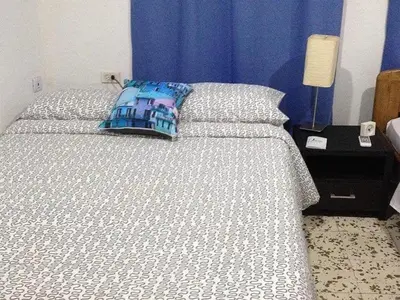 a bedroom with a bed with a pillow on it at B&B Grand Royal Inn in Barranquilla