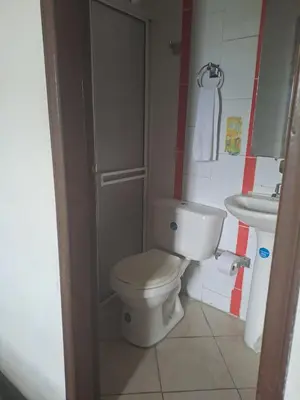 a small bathroom with a toilet and a sink at B&B Grand Royal Inn in Barranquilla