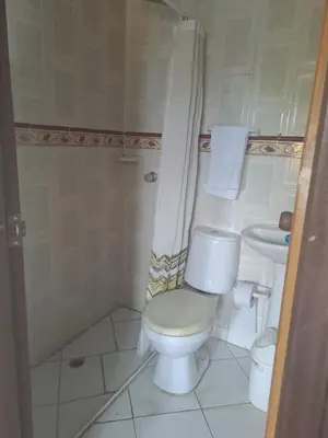 a bathroom with a toilet and a sink at B&B Grand Royal Inn in Barranquilla