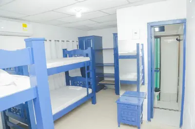 a room with blue bunk beds and a mirror at Cabaña Palma Azul in Coveñas