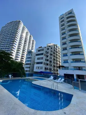 a swimming pool in front of two tall buildings at suite incanto con vista al lago in Cartagena de Indias