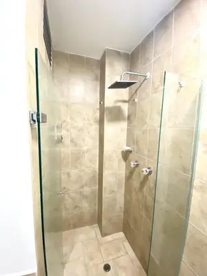 a shower with a glass door in a bathroom at suite incanto con vista al lago in Cartagena de Indias