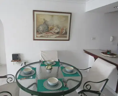 a glass table with two cups and saucers on it at Magia frente al Mar Caribe in Cartagena de Indias
