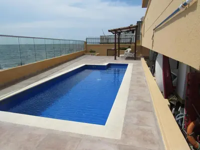 a swimming pool on the roof of a building with the ocean at Magia frente al Mar Caribe in Cartagena de Indias