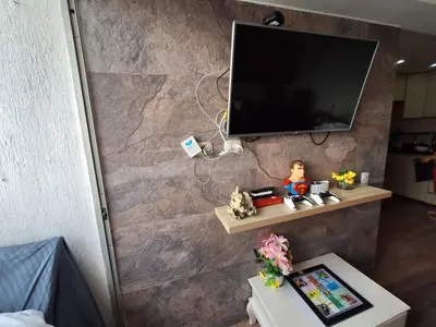 a living room with a tv on a wall at AQUALINASTAR in Cartagena de Indias