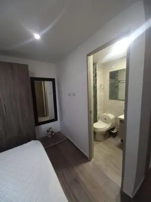 a bathroom with a bed and a sink and a toilet at AQUALINASTAR in Cartagena de Indias