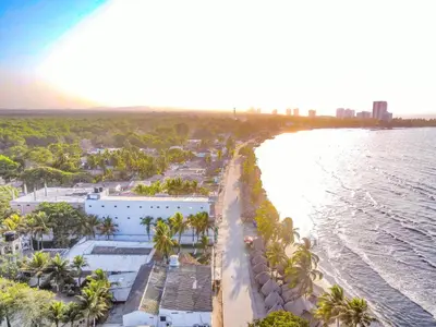 an aerial view of a beach with palm trees and the water at Hotel Palma Grande by Stanza in Coveñas