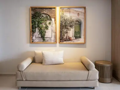 a couch in a room with two pictures on the wall at Wynwood Cartagena Beach in Cartagena de Indias
