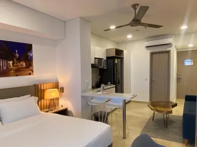a hotel room with a bed and a kitchen at Wynwood Cartagena Beach in Cartagena de Indias