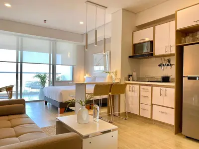 a kitchen and living room with a bed and a couch at Wynwood Cartagena Beach in Cartagena de Indias