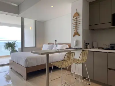 a bedroom with a bed and a table and chairs at Wynwood Cartagena Beach in Cartagena de Indias
