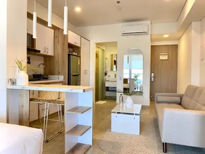 a kitchen and a living room with a couch at Wynwood Cartagena Beach in Cartagena de Indias