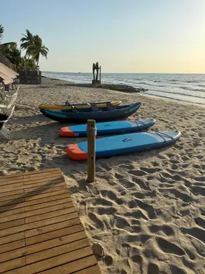 a group of kayaks lined up on the beach at JERUSALEMA BEACH GLAMPING in Tolú