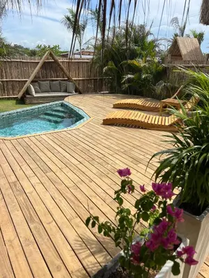 a wooden deck with a pool and a couch at JERUSALEMA BEACH GLAMPING in Tolú