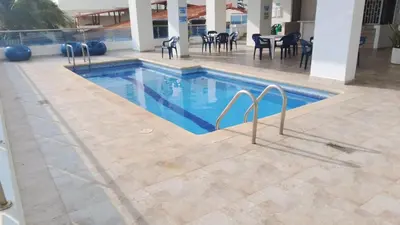 a swimming pool with blue water in a building at A un paso del mar in Cartagena de Indias
