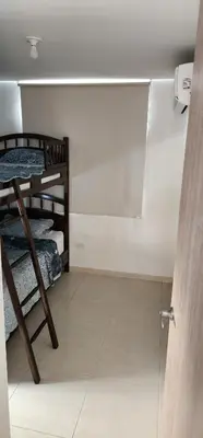 a room with two bunk beds and a glass door at Espectacular apartamento piso 14 al norte de Barranquilla in Barranquilla