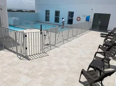 a person standing on the edge of a swimming pool at Apartamento cerca al Mar, en Cartagena COL in Cartagena de Indias