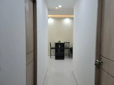 an open door to a room with a table at Apartamento cerca al Mar, en Cartagena COL in Cartagena de Indias