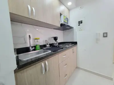 a small kitchen with a sink and a stove at Apartamento cerca al Mar, en Cartagena COL in Cartagena de Indias